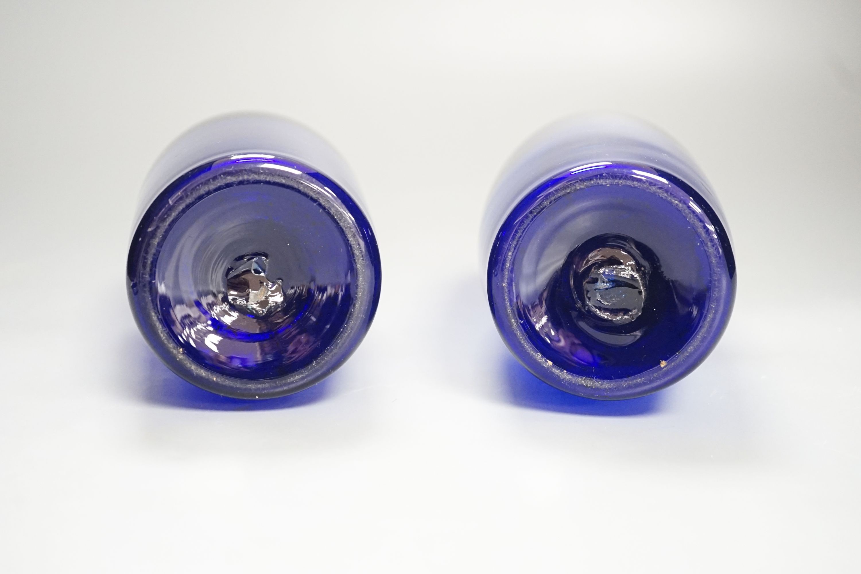A pair of 19th century blue glass bottles 29cm